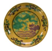 A Chinese yellow-ground green and aubergine enamelled 'dragon and phoenix' dish