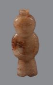 A Chinese jade celadon and brown jade figure