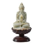 A large Chinese celadon and russet jade Buddha