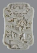 A Chinese pale celadon or white jade reticulated 'landscape' plaque