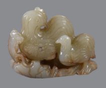 A Chinese celadon and russet jade &#8216;hen&#8217; group