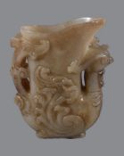 A Chinese celadon jade &#8216;phoenix&#8217; libation cup