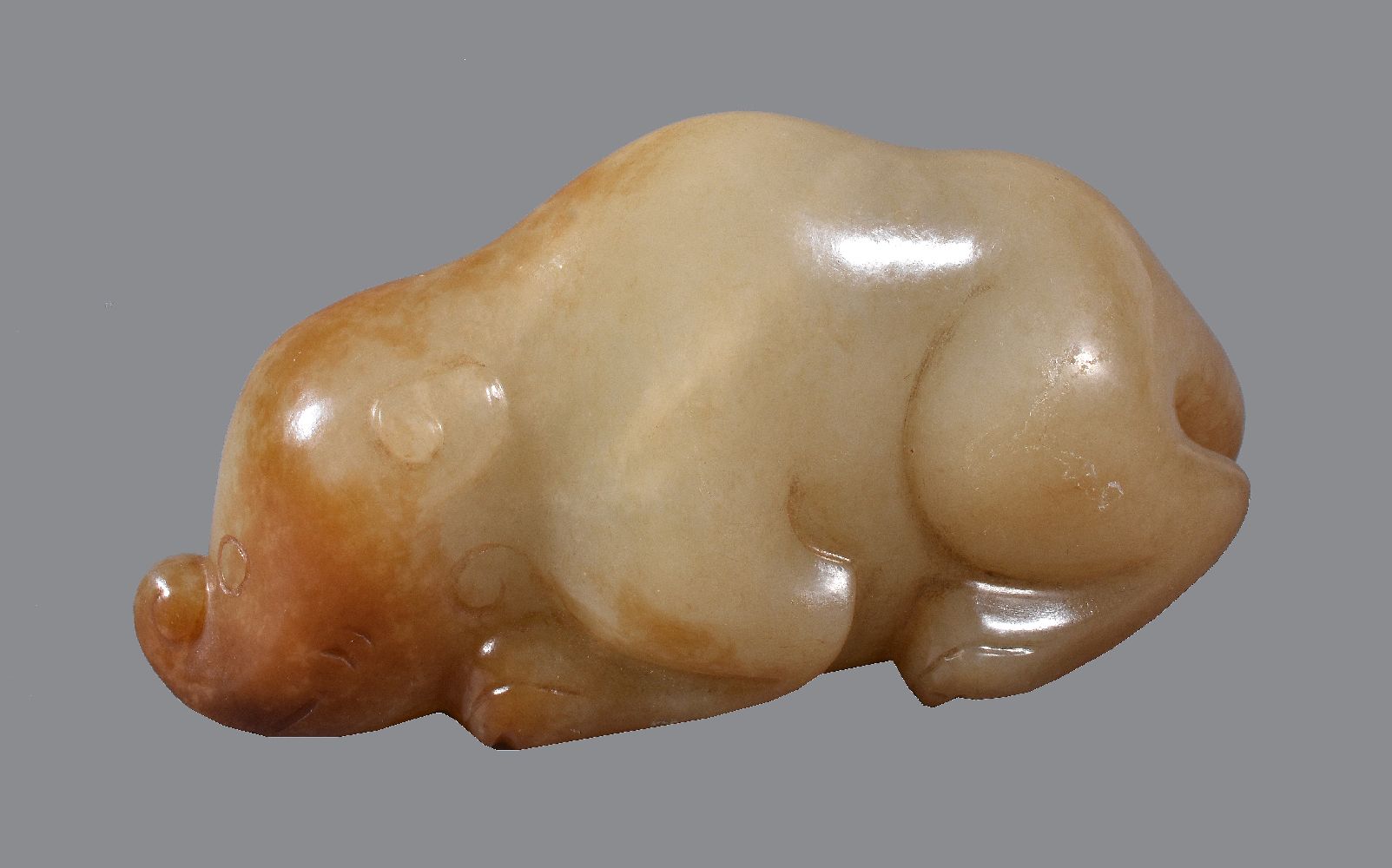 A Chinese celadon and russet jade animal carving