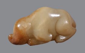 A Chinese celadon and russet jade animal carving