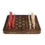 A Chinese export lacquer hinged games board and ivory chess set