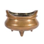 A Chinese bronze twin-handled tripod censer