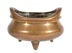 A Chinese bronze twin-handled tripod censer