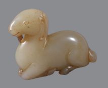 A Chinese pale celadon and russet jade &#8216;goat&#8217; carving