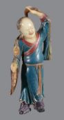 A Chinese soapstone figure of a Liuhai holding a string of money