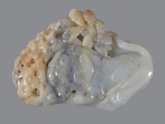 A Chinese grey and white jade &#8216;lion&#8217; carving