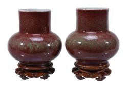 A pair of Chinese peach blossom-glazed bottle vases