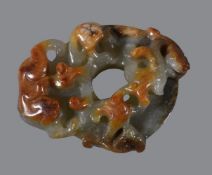 A Chinese celadon and russet jade &#8216;chilong&#8217; disk pendant