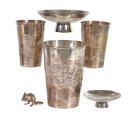 A Japanese Silver Beaker of tapered cylindrical form decorated in repousse with a dragon pursuing a