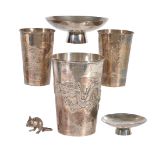 A Japanese Silver Beaker of tapered cylindrical form decorated in repousse with a dragon pursuing a