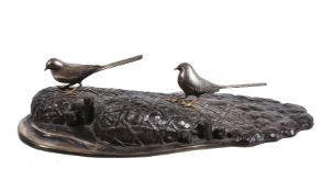 A Japanese Bronze and Silver Model depicting two long-tailed silvered and gilt birds perched atop tw