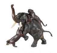 ϒ A Large Bronze Group of an Elephant raising its trunk in fear as it is attacked by two tigers