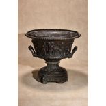 A Continental patinated bronze twin handled urn
