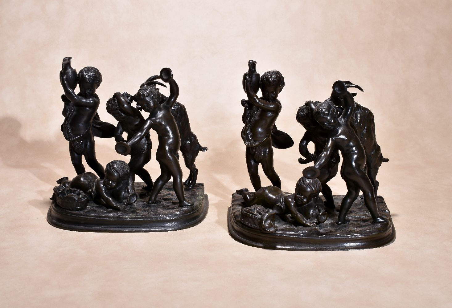 After Claude Michel, called Clodion, (French 1738 ~ 1814), a pair of patinated bronze Bacchic groups