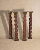 A set of four carved, painted and parcel giltwood and composition Solomonic columns,