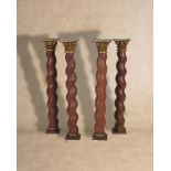 A set of four carved, painted and parcel giltwood and composition Solomonic columns,