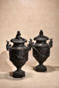 A pair of Continental patinated bronze urns and covers in Rococo taste