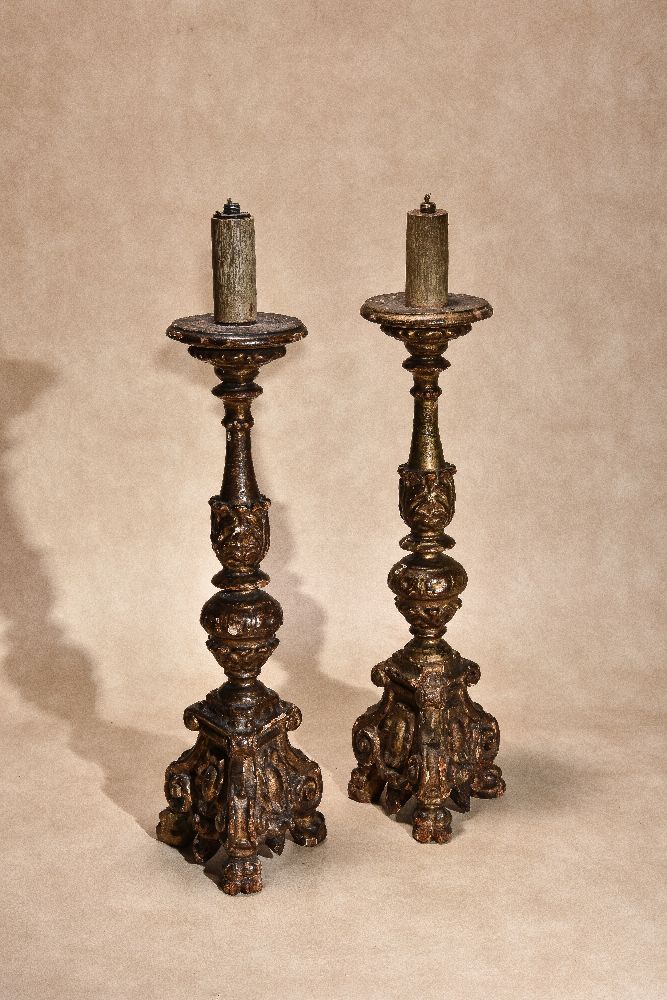 A pair of Italian carved and giltwood altar sticks