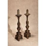 A pair of Italian carved and giltwood altar sticks