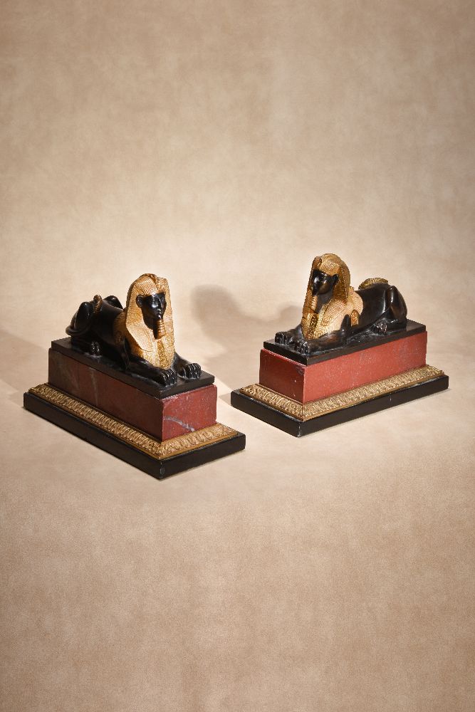 A pair of Continental gilt and patinated bronze and marble mounted models of recumbent sphinges