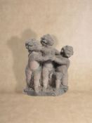 A sculpted sandstone group of three putti