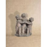 A sculpted sandstone group of three putti