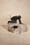 A Russian patinated bronze and rock crystal mounted group of an Inuit hunter and a seal