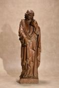 A Continental, probably French carved and stained beechwood model of a female saint,