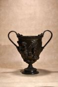 A patinated bronze twin handled urn in Neoclassical style