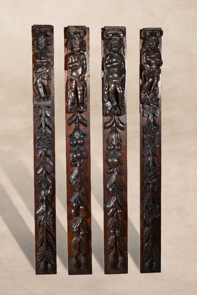 A set of four carved and stained oak terms