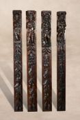 A set of four carved and stained oak terms