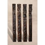 A set of four carved and stained oak terms