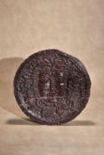 A recessed relief sculpted porphyry roundel depicting the face of Medusa