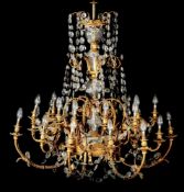 A substantial gilt metal and cut glass hung twenty four-light chandelier