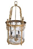 A substantial gilt bronze and glazed three light hall lantern in Regency taste