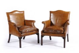 A pair of leather upholstered armchairs in George III style