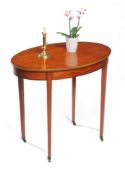 An Edwardian satinwood oval occasional or centre table