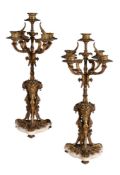 A pair of gilt bronze and white marble mounted five light table candelabra in Louis XVI style