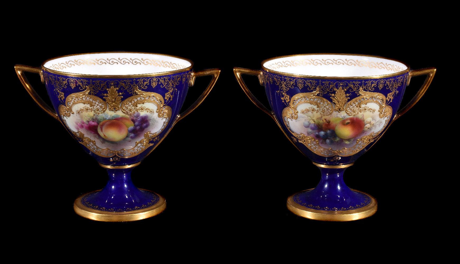 A pair of Royal Worcester blue-ground and gilt two-handled cabinet cups signed and painted by George