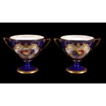 A pair of Royal Worcester blue-ground and gilt two-handled cabinet cups signed and painted by George