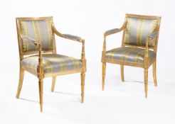 A pair of George III giltwood armchairs