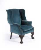 An Irish mahogany and upholstered wing armchair