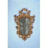 A Continental carved giltwood and etched glass wall mirror