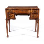 A George III mahogany serpentine fronted writing table