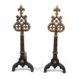 A pair of fine Victorian brass mounted cast iron andirons in Gothic style