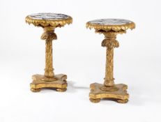 A pair of giltwood circular pedestal tables